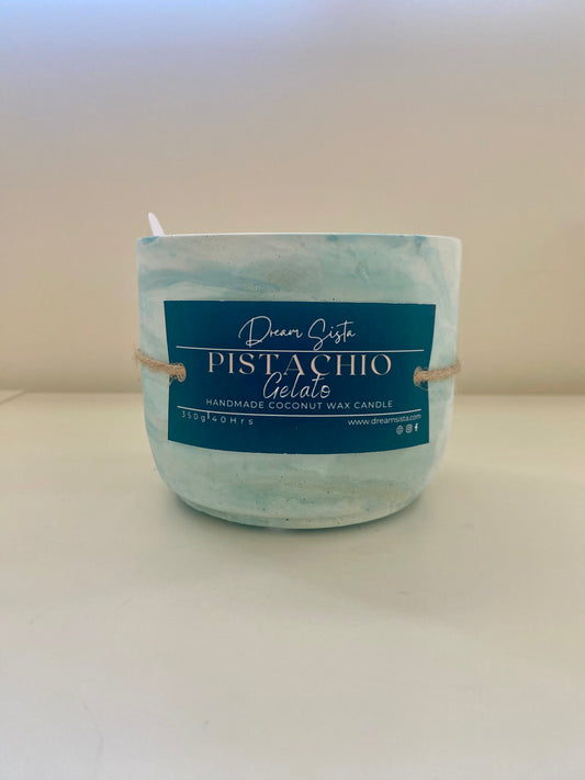 Pistachio gelato candle with a blue label on a white background